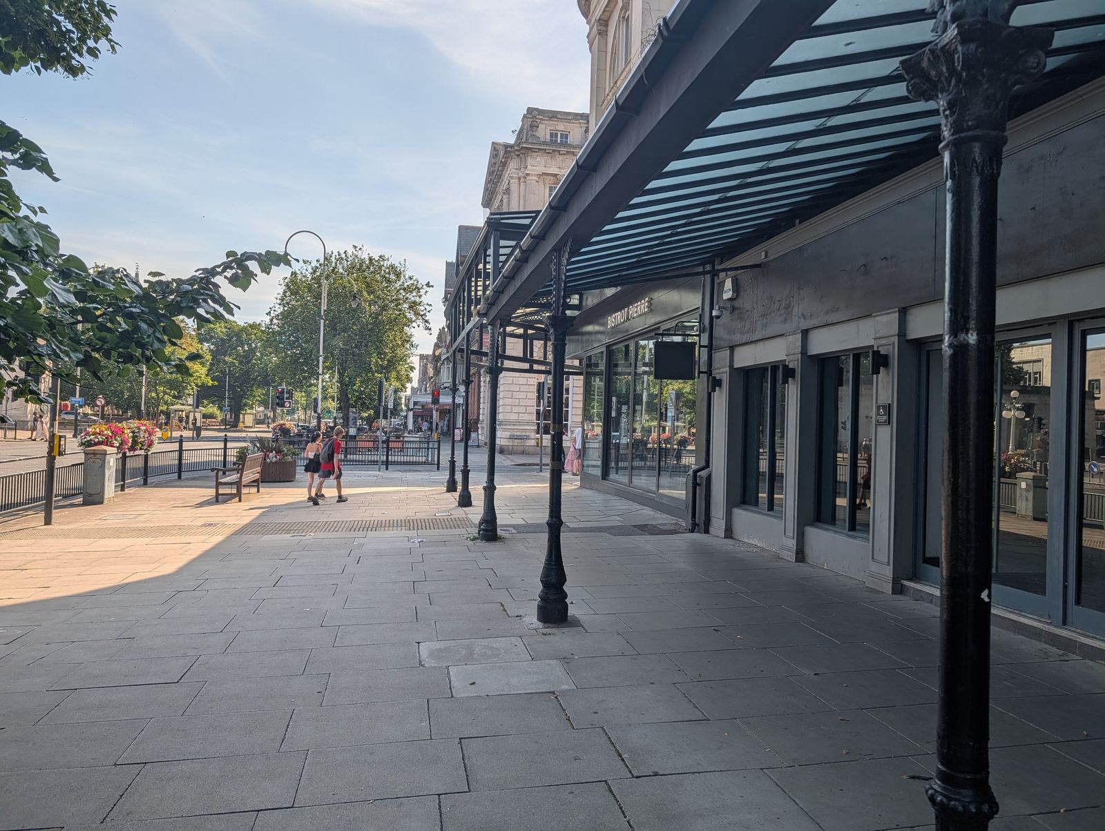 Lord Street, Southport: the glass-and-iron verandah with trees along the boulevard